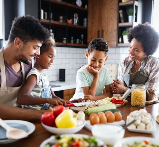 Happy family preparing healthy food in kitchen together