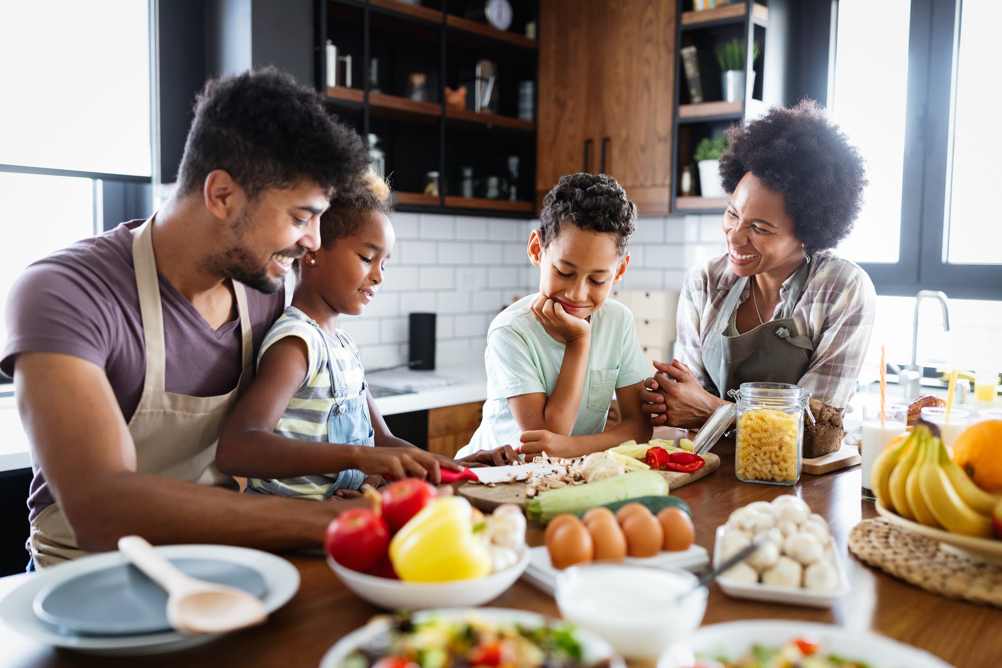 Happy family preparing healthy food in kitchen together